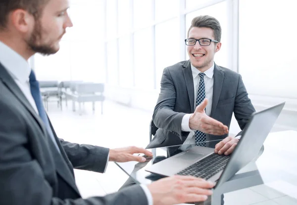 Close up .business partners discuss information sitting at the office table — стоковое фото