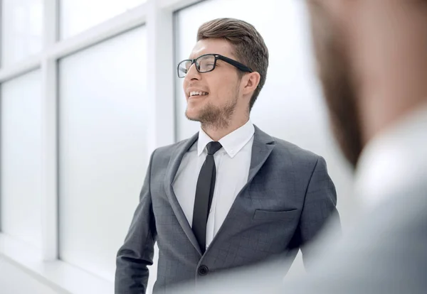 Junger Mitarbeiter steht im Büro. — Stockfoto