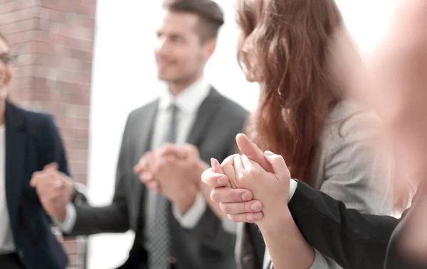 Business group in a circle holding hands indoors — Stock Photo, Image