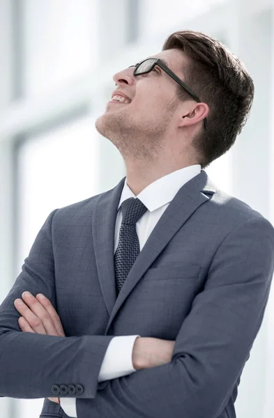 close up.young businessman looking up at copy space