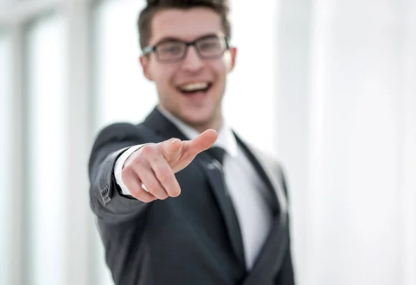 Close up. smiling young businessman pointing at you . — стоковое фото