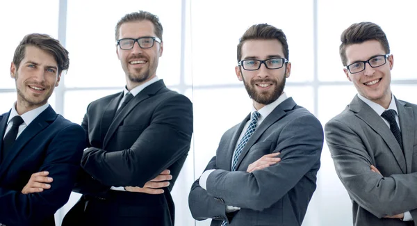 Smiling business people standing near the glass wall — Stock Photo, Image