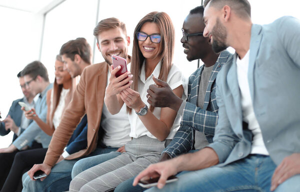group of young people with smartphones