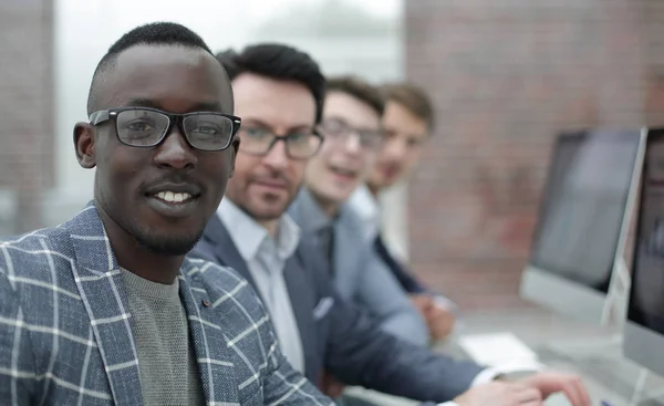 Jonge zakenman en zijn team van de business zitten aan de balie — Stockfoto