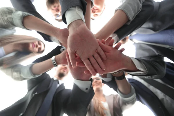 Fondo view.the equipo de negocios muestra su unidad — Foto de Stock