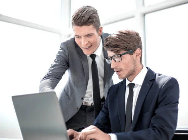 Mitarbeiter nutzen einen Laptop, um die benötigten Informationen zu überprüfen — Stockfoto