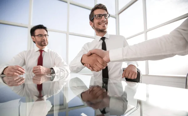 Handshake of young business partners at the office table — Stock Photo, Image