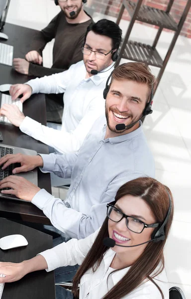 Close up. smiling call center specialists in the workplace — стоковое фото