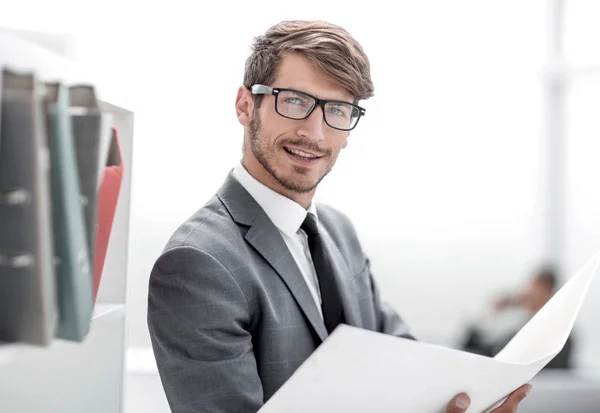 Handsome smiling businessman looking at documents — Stock Photo, Image