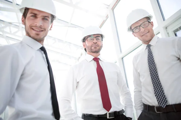 Close up.three businessman in a protective helmet — Stock Photo, Image