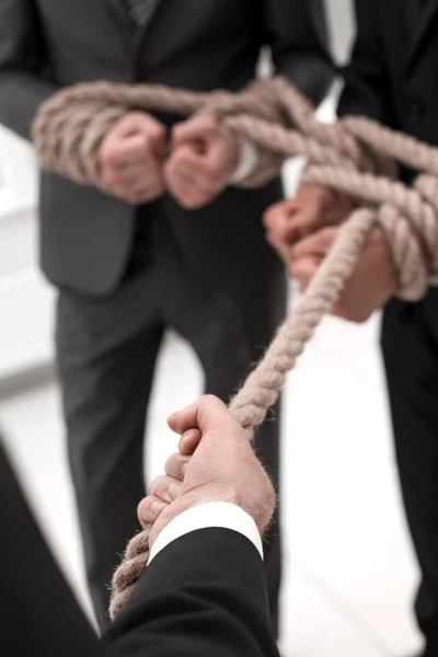 Close up.the boss pulls his own team over the rope — Stock Photo, Image