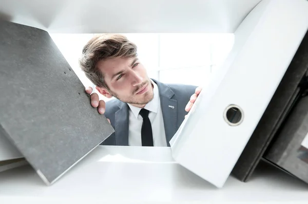 Man looks at documents in a closet — Stock Photo, Image