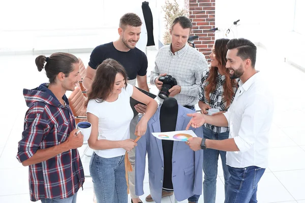 Groupe de concepteurs discutant de nouveaux modèles de vêtements pour hommes . — Photo