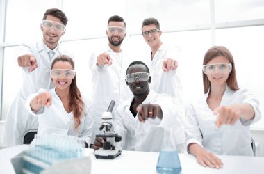 Grup genç başarılı bilim adamı kamera için poz