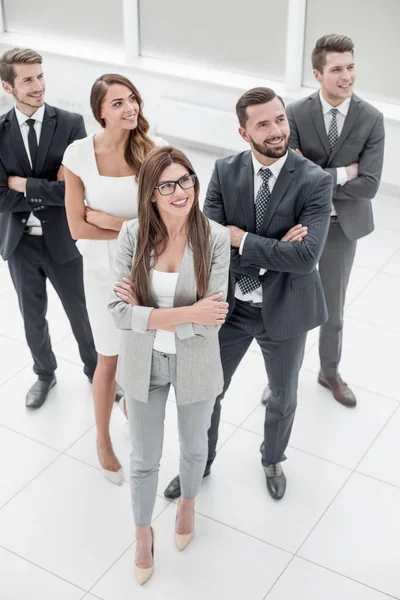 Smiling business team standing in the office — Stock Photo, Image