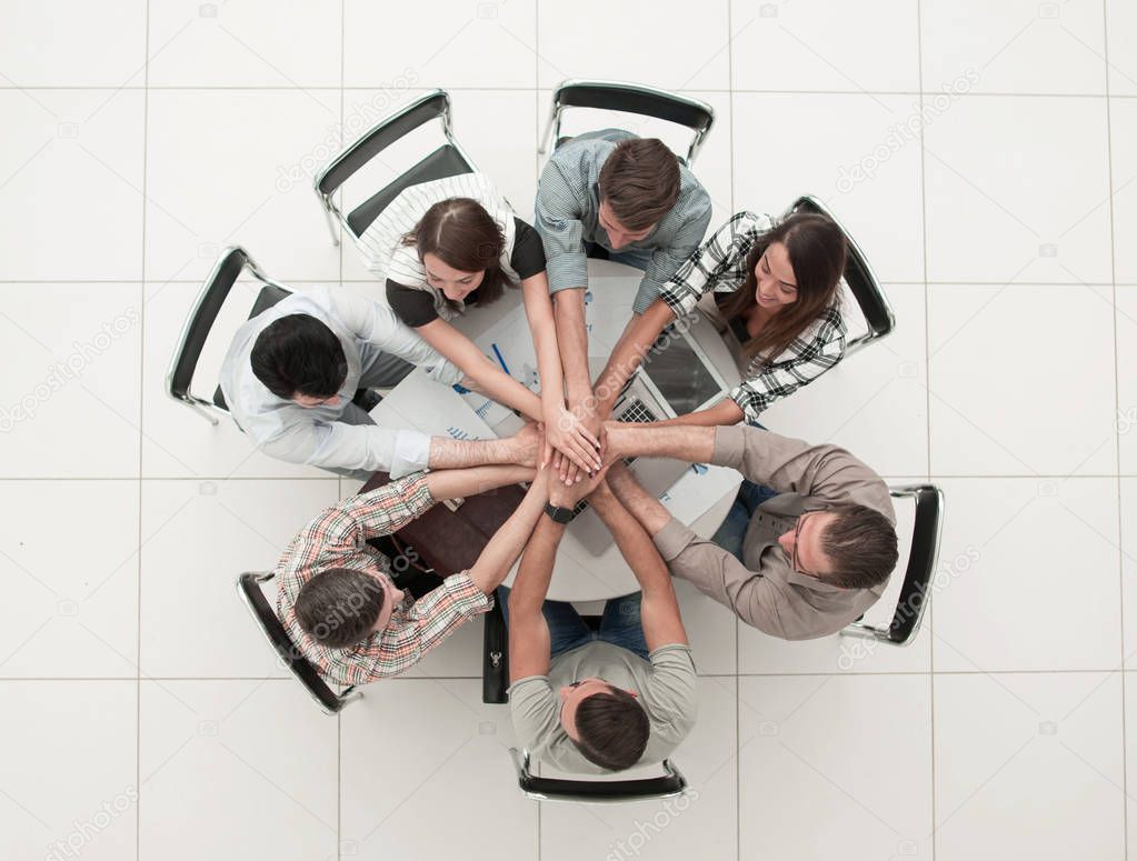 top view.successful business team by folding their hands together. start-up