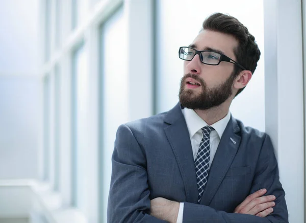 Close up. pensive businessman standing in the office — стоковое фото