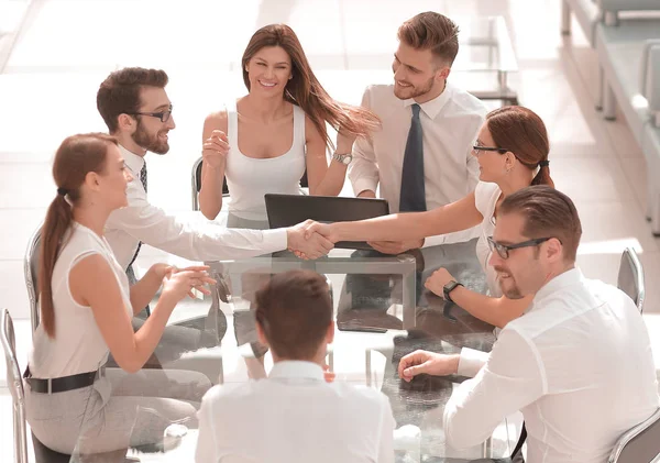 Handshake business partners at the negotiating table — Stock Photo, Image