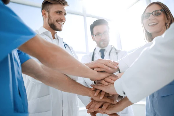 Group of doctors with their hands folded together — Stock Photo, Image