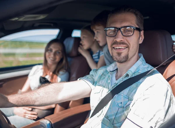 Side view.happy father driving a car — Stock Photo, Image