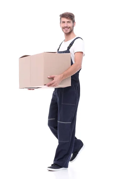 In full growth.a man carries a large cardboard box — Stock Photo, Image