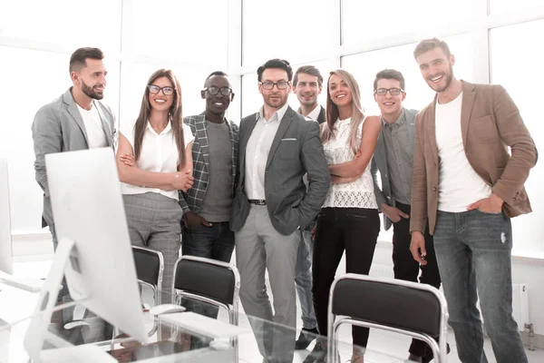 Multinational business team standing in a bright office — Stock Photo, Image