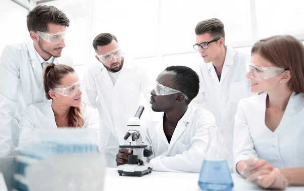 专注和严重的女性和男性化学家在实验室外套和 sa — 图库照片
