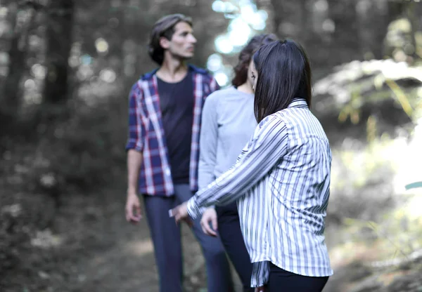 young people walking in the woods