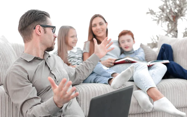 Happy family discussing something sitting in their living room. — Stock Photo, Image