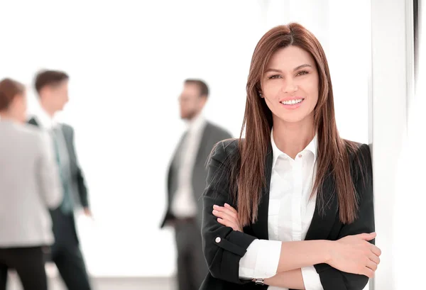 Young business woman on blurred office background. Stock Picture