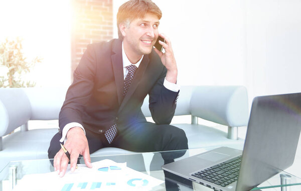 Confident businessman sitting at office desk