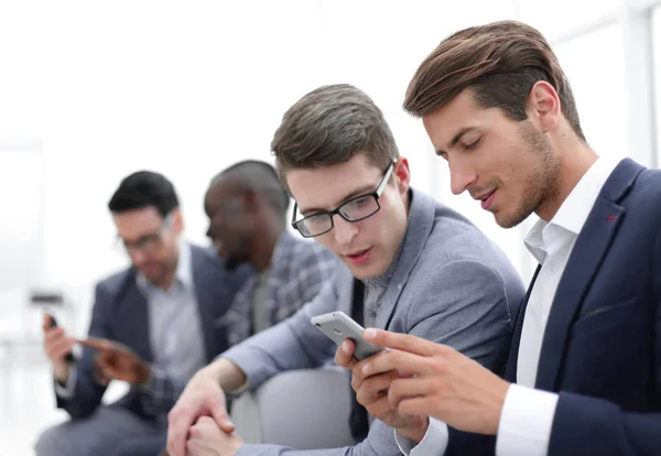 business colleagues reading SMS on smartphone