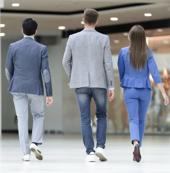 Bakre view.business kollegor promenad i office hall — Stockfoto