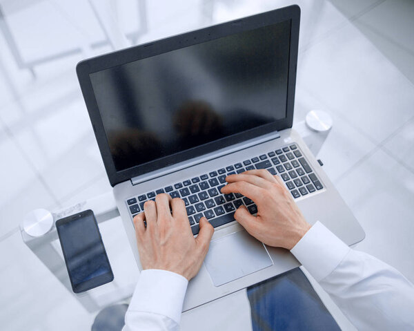 rear view.businessman typing on a laptop.