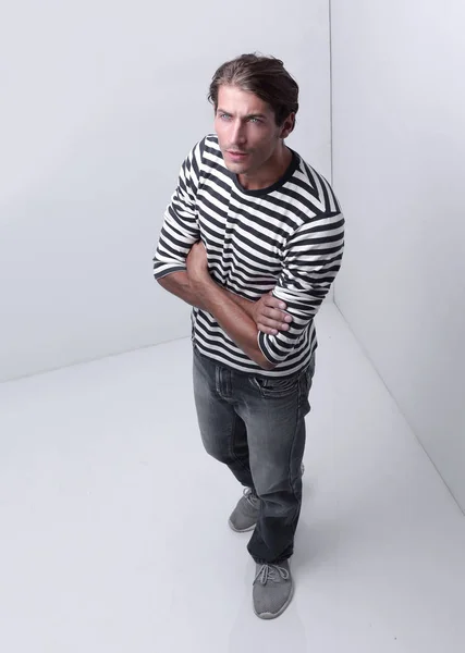 modern man standing in the corner of the white room .