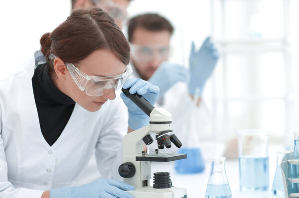 female scientists looking into a microscope.photo with copy space