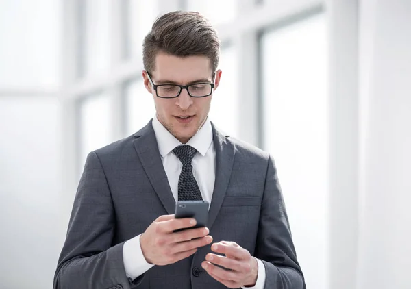 Ung affärsman läsa Sms på sin smartphone — Stockfoto