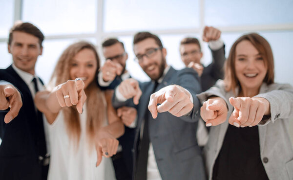 close up.a group of young business people pointing at you