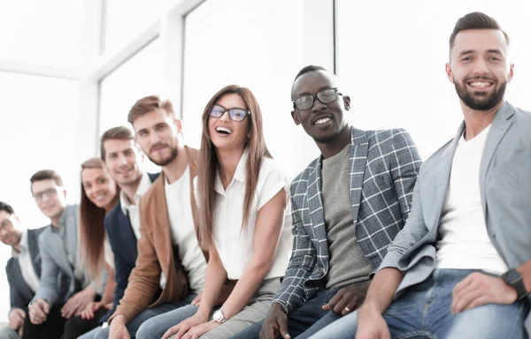 Young people sitting at the wall waiting for their turn at the interview — Stock Photo, Image
