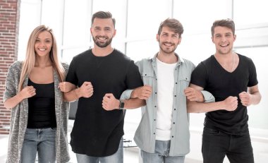 Gülümseyen iş adamları ofiste kameraya bakıyorlar.