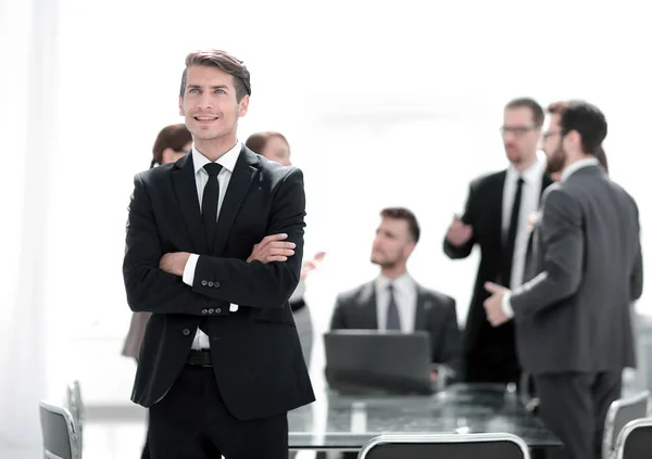 Dreaming businessman on the background of the office. — Stock Photo, Image