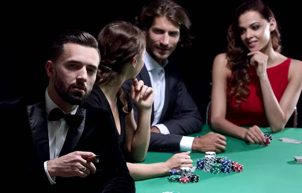 Man with cigar looking up from poker game in casino — Stock Photo, Image