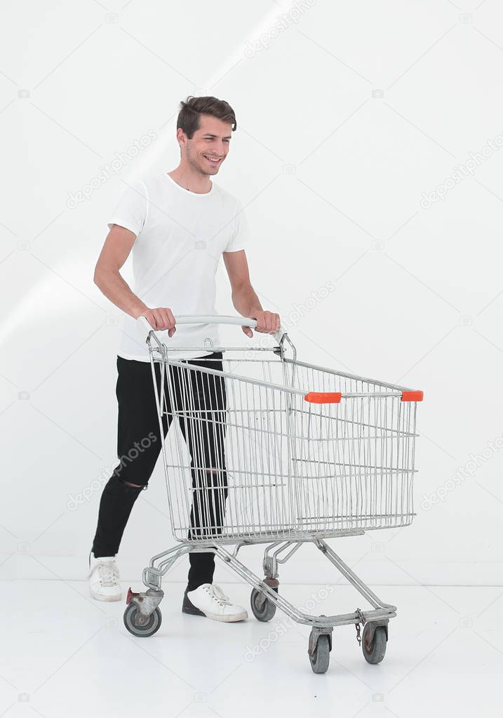 smiling man pushing shopping cart.