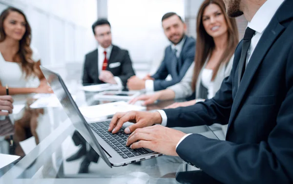 Zakenman met behulp van de laptop tijdens een vergadering van de Raad van bestuur — Stockfoto