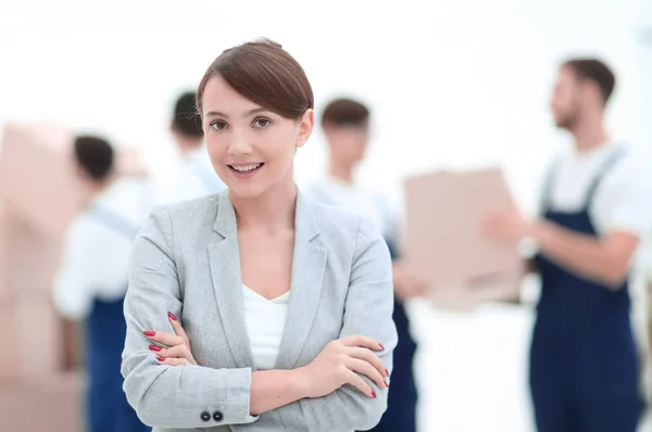 Woman manager holding clipboard on blurred background with mover