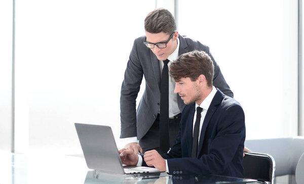 business people discuss something sitting at the office table.