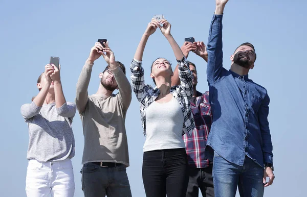 group of young people with smartphones