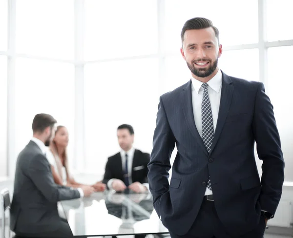 Joven hombre de negocios de pie en una oficina brillante — Foto de Stock