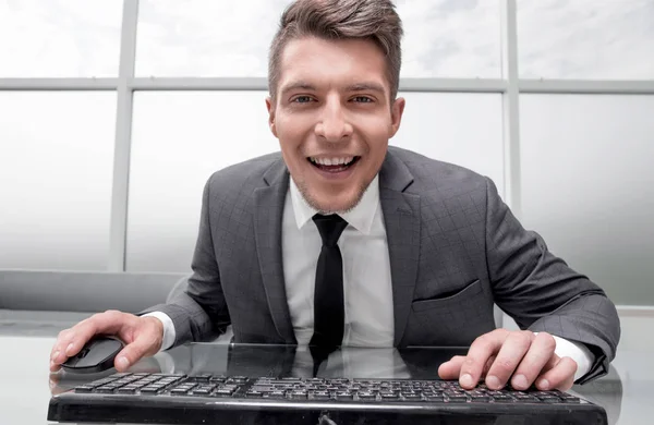 Young businessman sitting in his office looking at camera — Stock Photo, Image