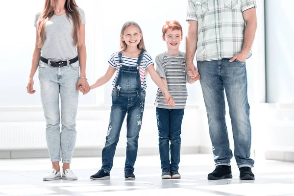 Modern family standing in a new apartment — Stock Photo, Image